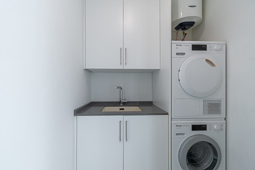 Utility room with washing machine and dryer