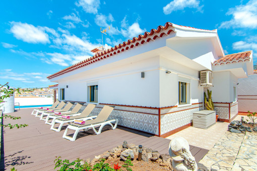 Sunny terrace with sun loungers