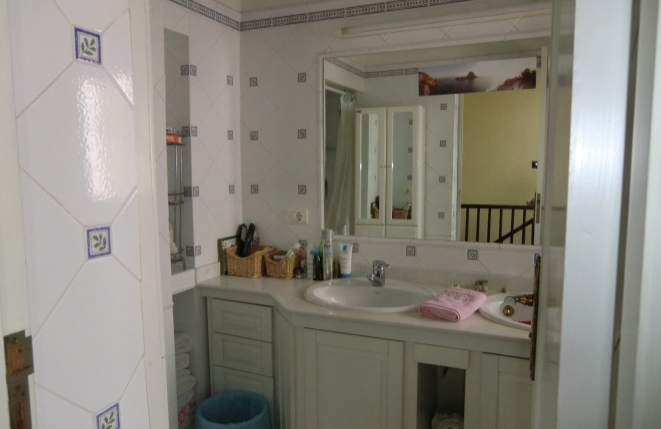 Shared bathroom with large mirror